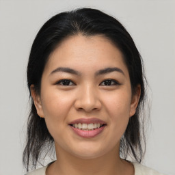 Joyful asian young-adult female with medium  brown hair and brown eyes