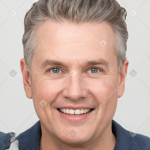 Joyful white adult male with short  brown hair and grey eyes