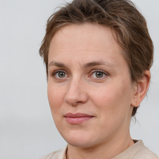 Joyful white adult female with short  brown hair and grey eyes