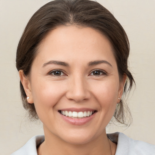 Joyful white young-adult female with medium  brown hair and brown eyes