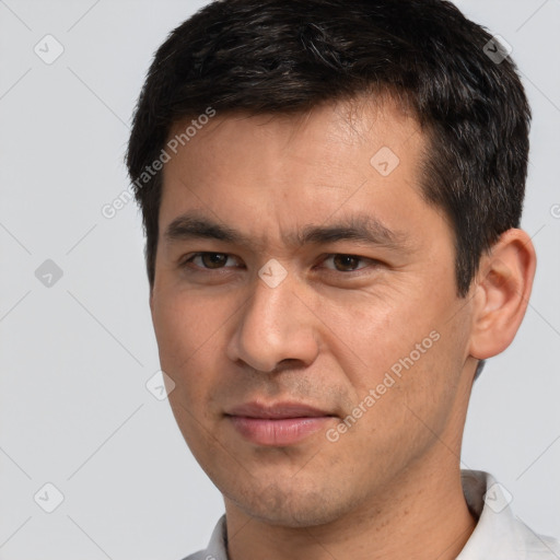 Joyful white adult male with short  brown hair and brown eyes