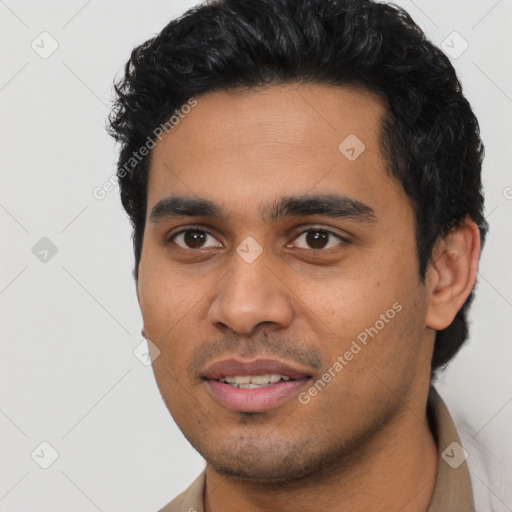 Joyful latino young-adult male with short  black hair and brown eyes