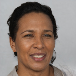 Joyful black adult female with short  brown hair and brown eyes