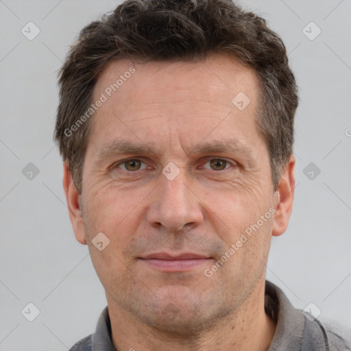 Joyful white adult male with short  brown hair and grey eyes