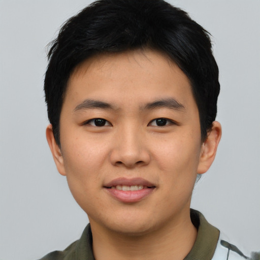 Joyful asian young-adult male with short  black hair and brown eyes