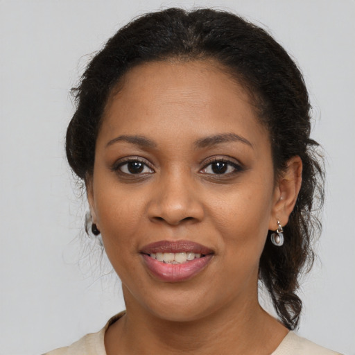 Joyful black young-adult female with medium  brown hair and brown eyes