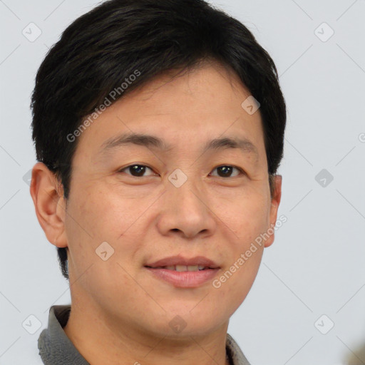 Joyful asian young-adult male with short  brown hair and brown eyes