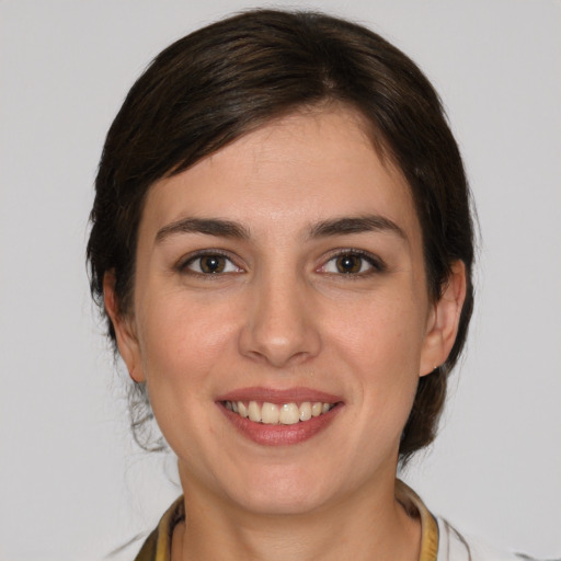 Joyful white young-adult female with medium  brown hair and brown eyes