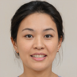 Joyful asian young-adult female with medium  brown hair and brown eyes