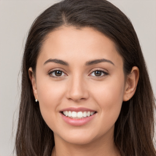 Joyful white young-adult female with long  brown hair and brown eyes