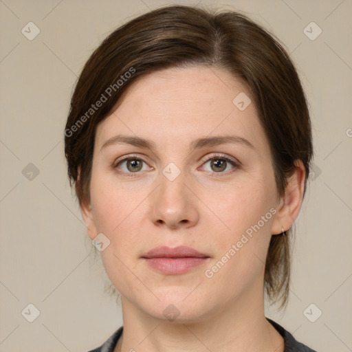 Joyful white young-adult female with medium  brown hair and green eyes