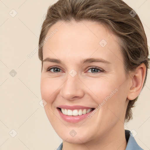 Joyful white young-adult female with medium  brown hair and grey eyes