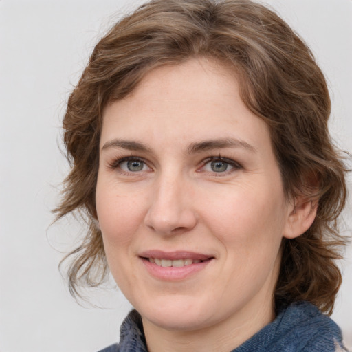 Joyful white young-adult female with medium  brown hair and blue eyes