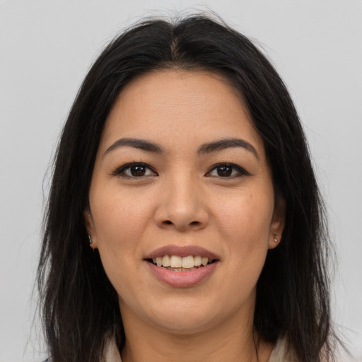 Joyful asian young-adult female with long  brown hair and brown eyes