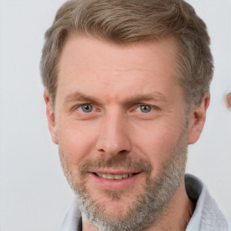 Joyful white adult male with short  brown hair and grey eyes