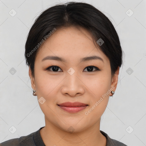 Joyful asian young-adult female with short  brown hair and brown eyes