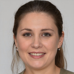 Joyful white young-adult female with medium  brown hair and grey eyes