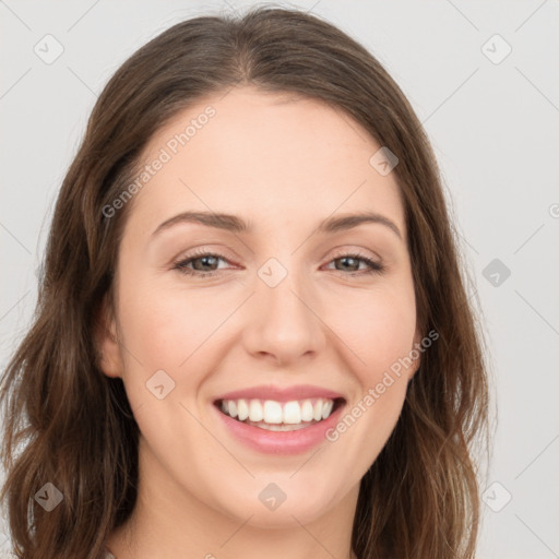 Joyful white young-adult female with long  brown hair and green eyes