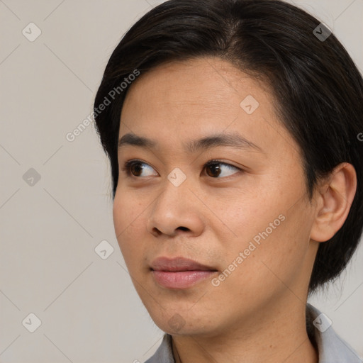 Joyful asian young-adult female with medium  black hair and brown eyes