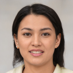 Joyful latino young-adult female with medium  brown hair and brown eyes