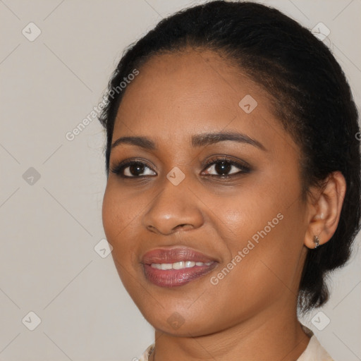 Joyful black young-adult female with medium  brown hair and brown eyes