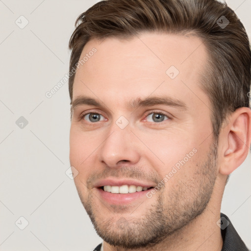 Joyful white young-adult male with short  brown hair and grey eyes