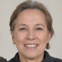 Joyful white adult female with medium  brown hair and grey eyes