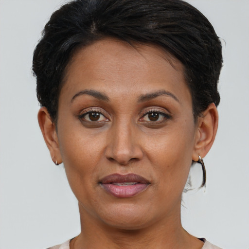Joyful latino adult female with short  brown hair and brown eyes