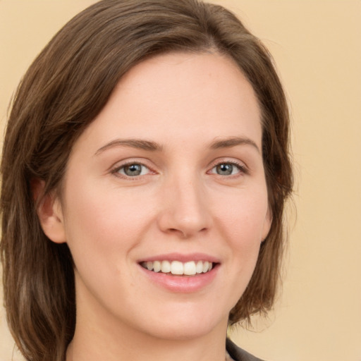 Joyful white young-adult female with medium  brown hair and green eyes