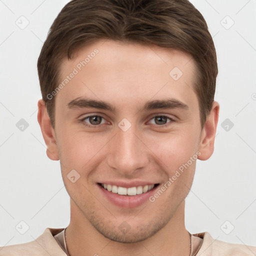 Joyful white young-adult male with short  brown hair and grey eyes