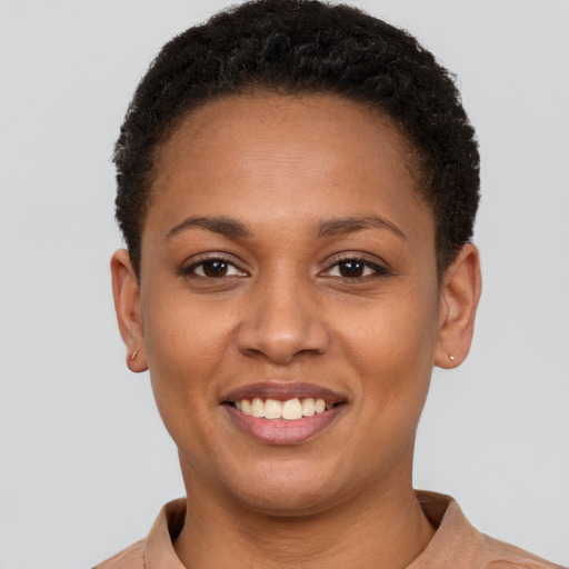 Joyful black young-adult female with short  brown hair and brown eyes