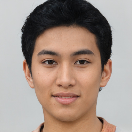 Joyful asian young-adult male with short  black hair and brown eyes