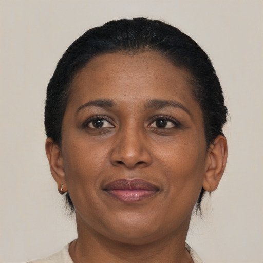 Joyful black adult female with short  brown hair and brown eyes