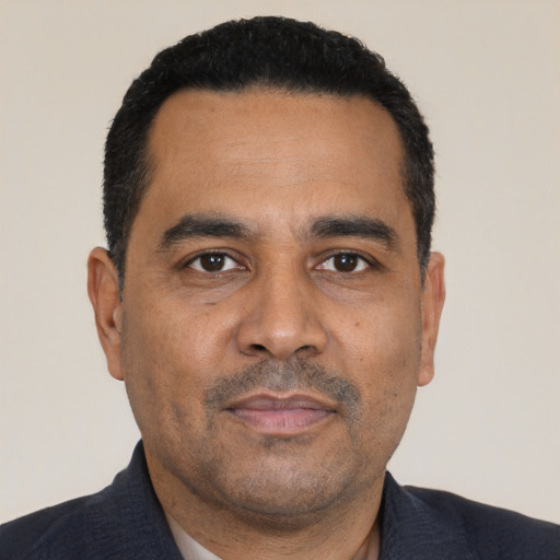 Neutral latino adult male with short  black hair and brown eyes