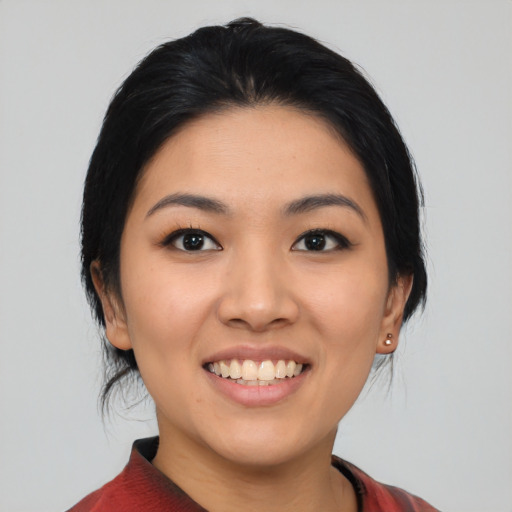 Joyful asian young-adult female with medium  black hair and brown eyes