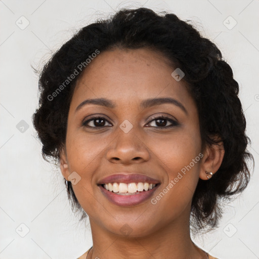 Joyful black young-adult female with long  brown hair and brown eyes