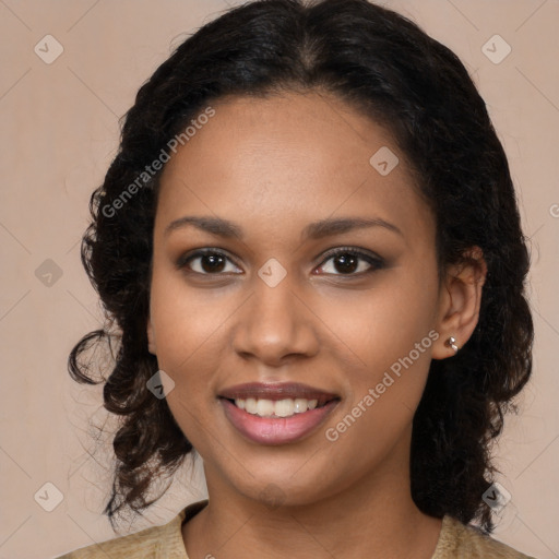 Joyful black young-adult female with long  brown hair and brown eyes