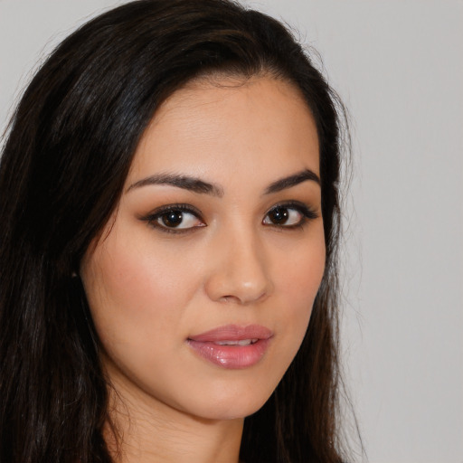 Joyful latino young-adult female with long  brown hair and brown eyes