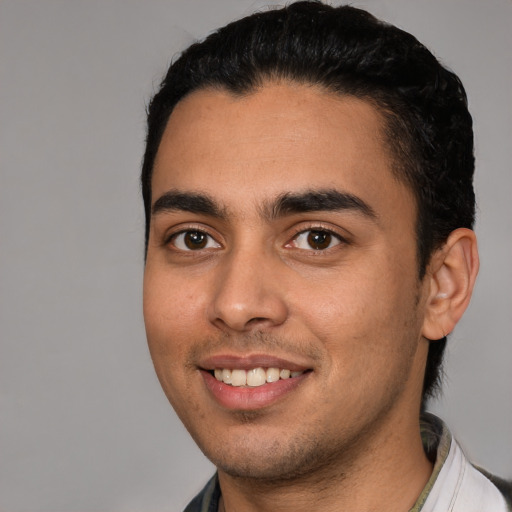 Joyful white young-adult male with short  black hair and brown eyes