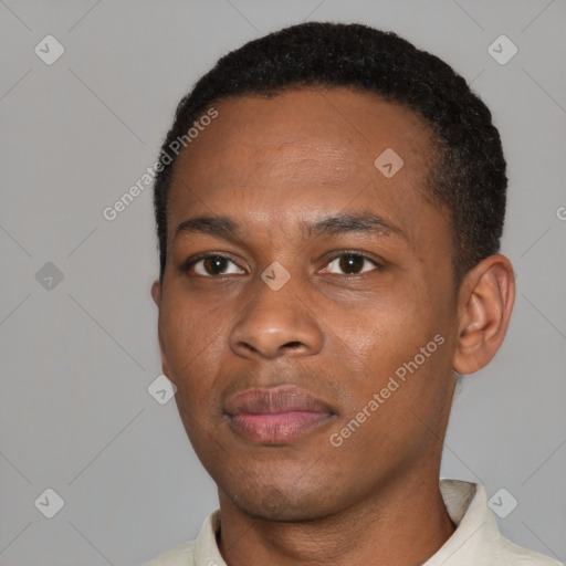 Joyful black young-adult male with short  black hair and brown eyes