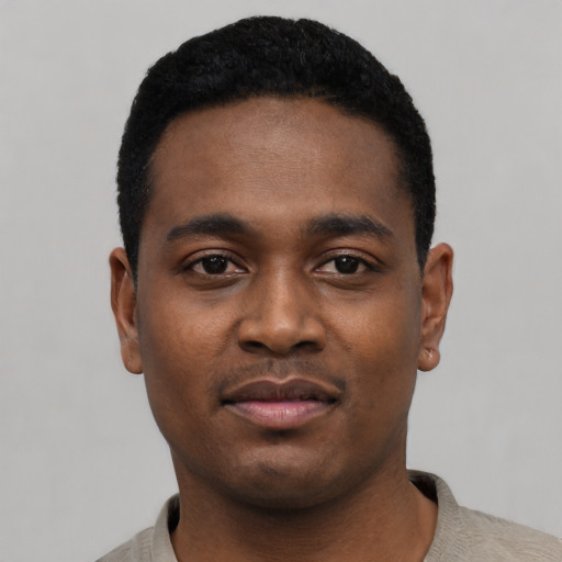 Joyful black young-adult male with short  black hair and brown eyes