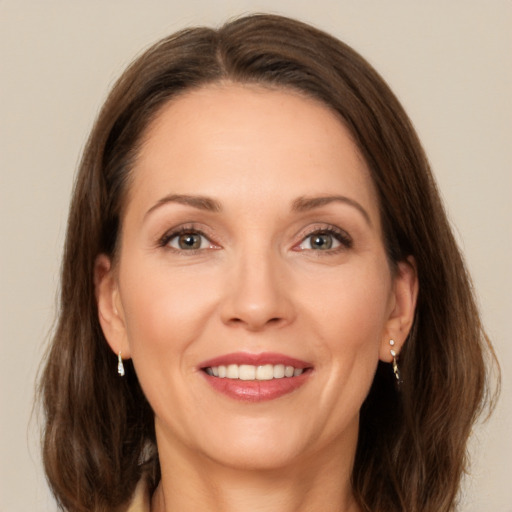 Joyful white adult female with medium  brown hair and brown eyes