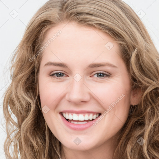 Joyful white young-adult female with long  brown hair and blue eyes