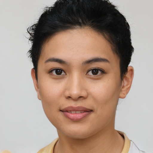 Joyful latino young-adult female with short  brown hair and brown eyes