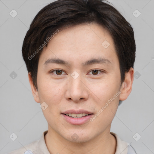 Joyful asian young-adult male with short  brown hair and brown eyes