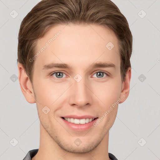 Joyful white young-adult male with short  brown hair and grey eyes