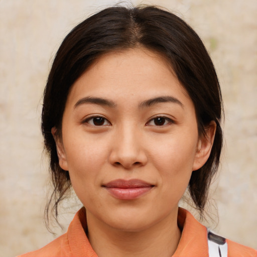 Joyful white young-adult female with medium  brown hair and brown eyes