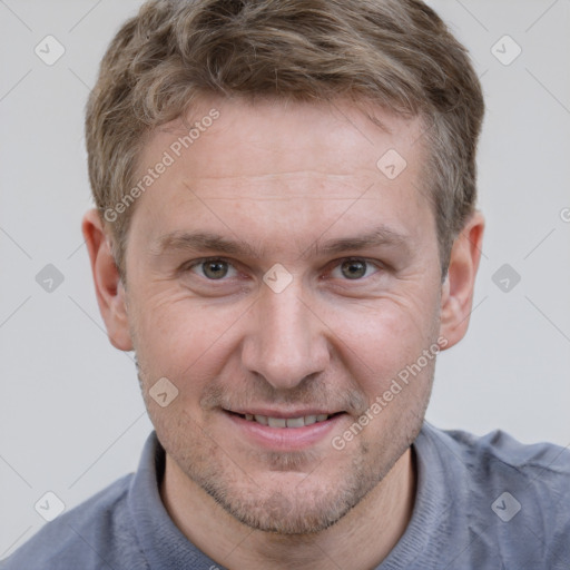 Joyful white adult male with short  brown hair and grey eyes