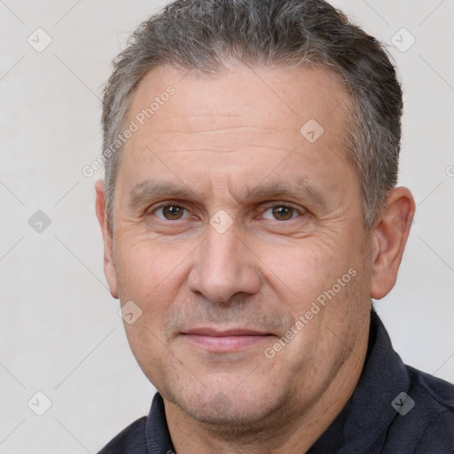 Joyful white middle-aged male with short  brown hair and brown eyes