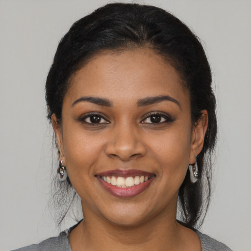 Joyful latino young-adult female with medium  black hair and brown eyes